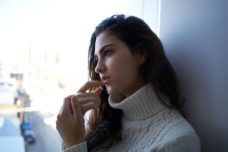 woman near the window with red cup and plaidの写真素材