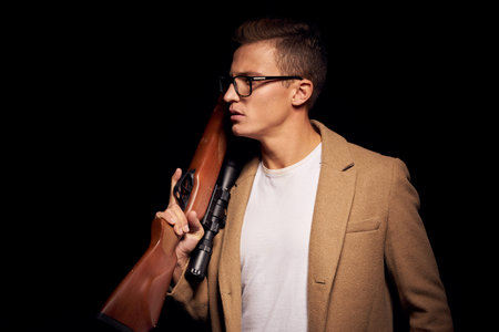 portrait of a man with a gun in hand security hunter isolated background
