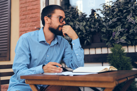 business man with papers in a summer cafe work communication