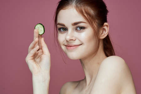 cheerful woman cucumbers vitamins clean skin healthの写真素材