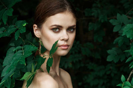 portrait of a woman green leaves clean skin nature summer close-upの写真素材
