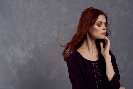 woman with red hair posing fashionable clothing elegant styleの写真素材