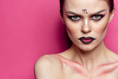 attractive woman naked shoulders cosmetics bright makeup pink backgroundの写真素材