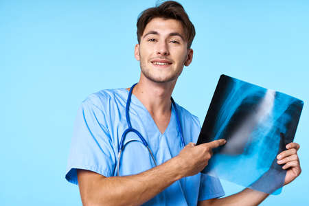 male doctor x-ray diagnostics stethoscope examination work blue backgroundの写真素材