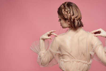 pretty woman hairstyle fun posing cosmetics fashion pink backgroundの写真素材