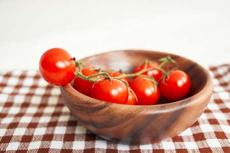 Ingredients Cherry tomatoes on a cutting board wood backgroundの写真素材