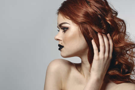 red-haired woman with bare shoulders bright makeup base zodiac sign horoscopeの写真素材