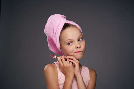 girl with a towel on her head cosmetics skin care gray backgroundの写真素材