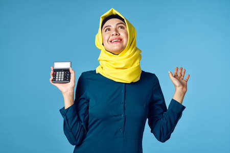woman in yellow hijab technology calculator work financeの写真素材