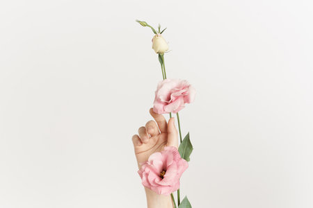 bouquet of flowers in hands close-up light background decoration beautyの写真素材