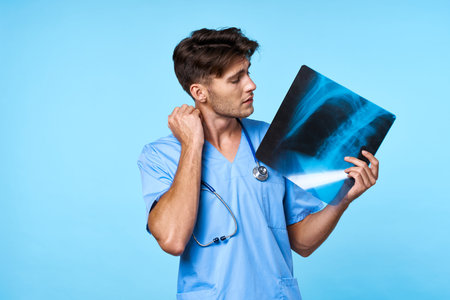 male doctor x-ray diagnostics stethoscope examination work blue background