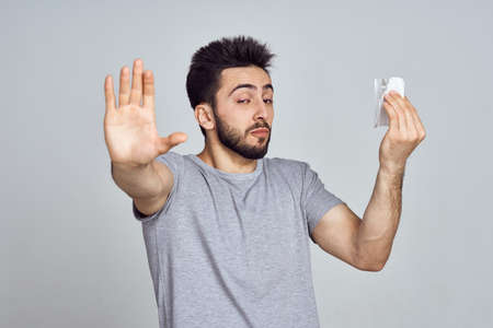 bearded man in white t-shirt posing gesturing with his handsの写真素材
