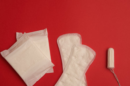 pads tampons underwear feminine hygiene red background