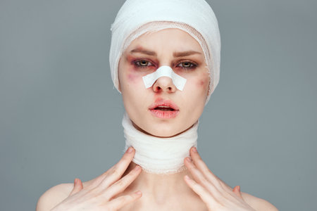 woman in blue gloves syringe in hands contour on the face lifting isolated backgroundの写真素材