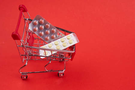 small trolley with medicines pharmacy shop pills shoppingの写真素材