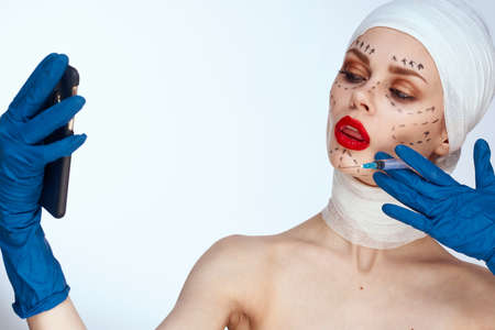 female patient Red lips plastic surgery operation bare shoulders studio lifestyleの写真素材