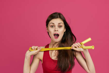 athletic woman workout health slim figure pink backgroundの写真素材