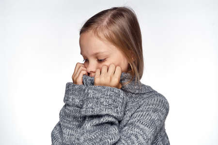 girl in sweater temperature health problems light backgroundの写真素材
