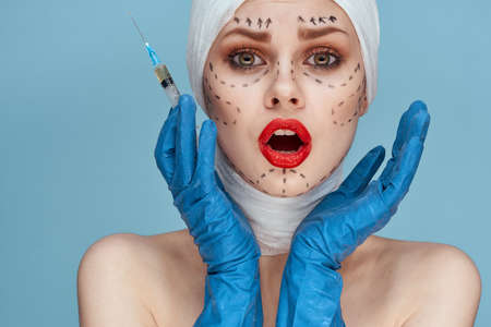 a person Red lips plastic surgery operation bare shoulders blue backgroundの写真素材