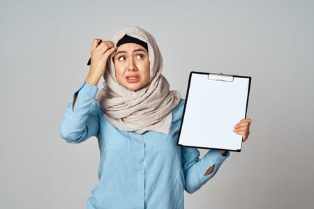 Muslim woman in hijab documents office work