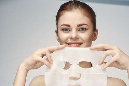 woman with mask in hands skin care rejuvenation spa treatmentsの写真素材