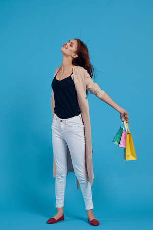 beautiful woman with packages in hands Shopaholic isolated backgroundの写真素材