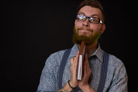 man in glasses with a notebook in his hands training professional officeの写真素材