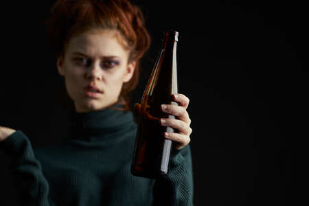 woman with cigarette bottle of alcohol bruises under eyes problems depressionの写真素材