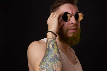 bearded man in white t-shirt with tattoos on his arms posing bullyの写真素材
