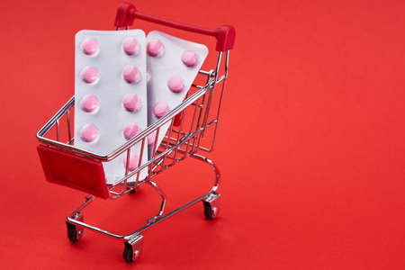 small trolley with medicines pharmacy shop pills shoppingの写真素材