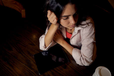 cheerful woman sitting in a cafe in front of a laptop communication internet lifestyleの写真素材