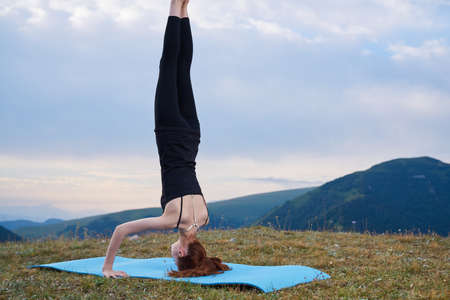 sportive woman workout meditation in the mountains outdoorsの写真素材