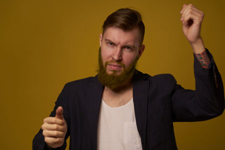 bearded man fashionable hairstyle jacket posing self confidenceの写真素材