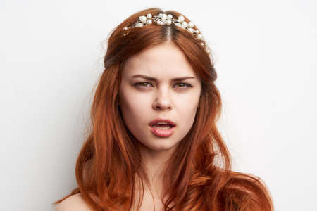 charming woman with fashionable hairstyle makeup emotions light backgroundの写真素材