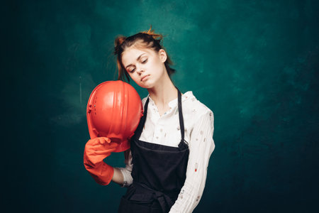 woman in black apron orange hard hat protection cleaning