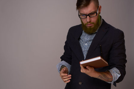 portrait of a business man wearing glasses with a beard posing an official