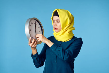 woman in yellow hijab technology calculator work finance