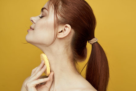 pretty woman with sponges in her hands bare shoulders clean skin hygiene