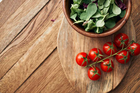 a plate of lettuce cherry tomatoes cooking ingredients organic healthy foodの写真素材