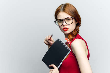 Business woman in red dress notebook pencil professionalsの写真素材