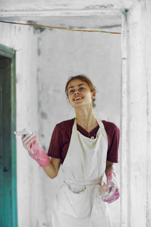 cheerful woman painter In a white apron home renovationの写真素材