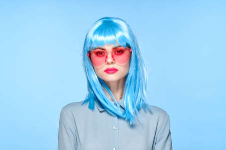 cheerful glamorous woman in pink glasses purple wig fashionの写真素材