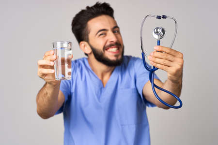 doctor nutritionist glass of water health close up stethoscopeの写真素材