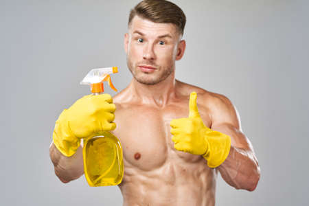 funny pumped up man rubber gloves detergents serviceの写真素材