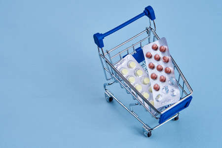 packs of pills in a trolley shopping in a pharmacy medicinesの写真素材