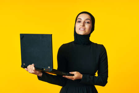 cheerful woman laptop in hands learning student emotions ethnicity modelの写真素材