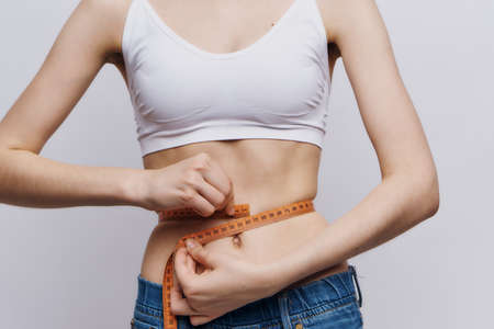 woman measure waist slim figure diet lifestyleの写真素材