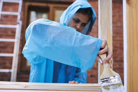 women paint wooden structures brush painter decorationの写真素材