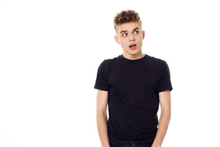 guy in black t-shirt posing light backgroundの写真素材