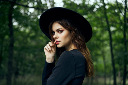 woman dressed as a witch in the forest Halloween fantasy ritual